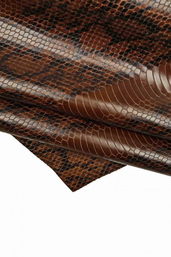 REPTILE printed leather hide, black brown glossy python textured calfskin, snake pattern on a slightly stiff cowhide