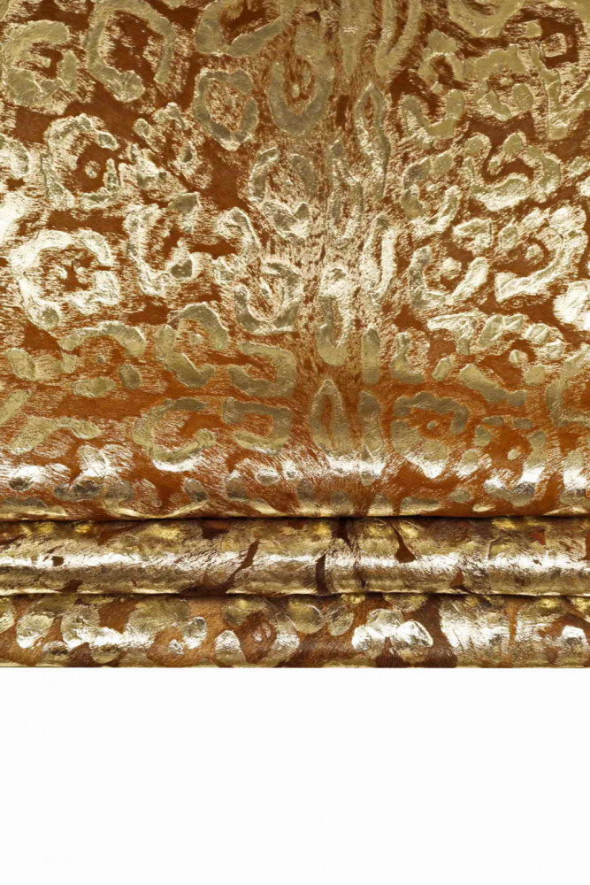 Leopard printed metallic hair on leather hide, brown pony calfskin with light gold animal texture, medium softness